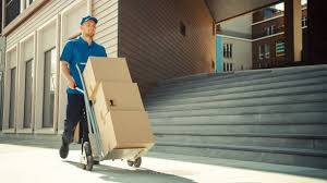 Mover transporting furniture with a hand truck